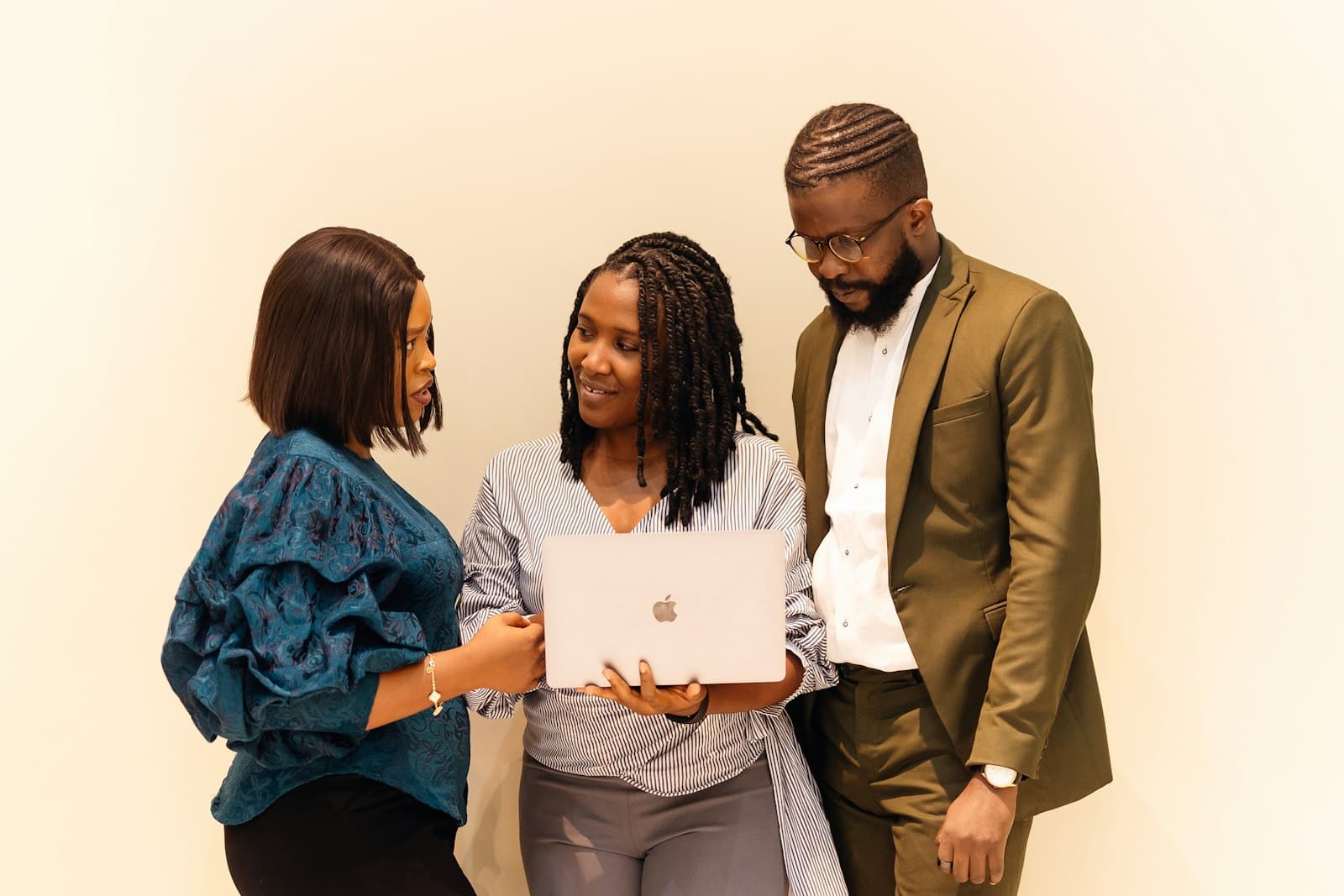 Colleagues gathered around a laptop