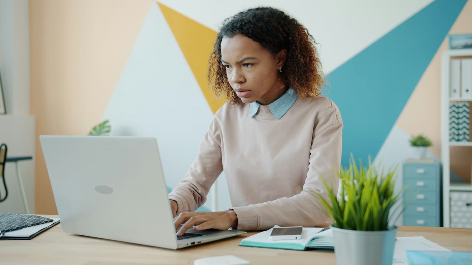Focused professional working through tasks on a laptop