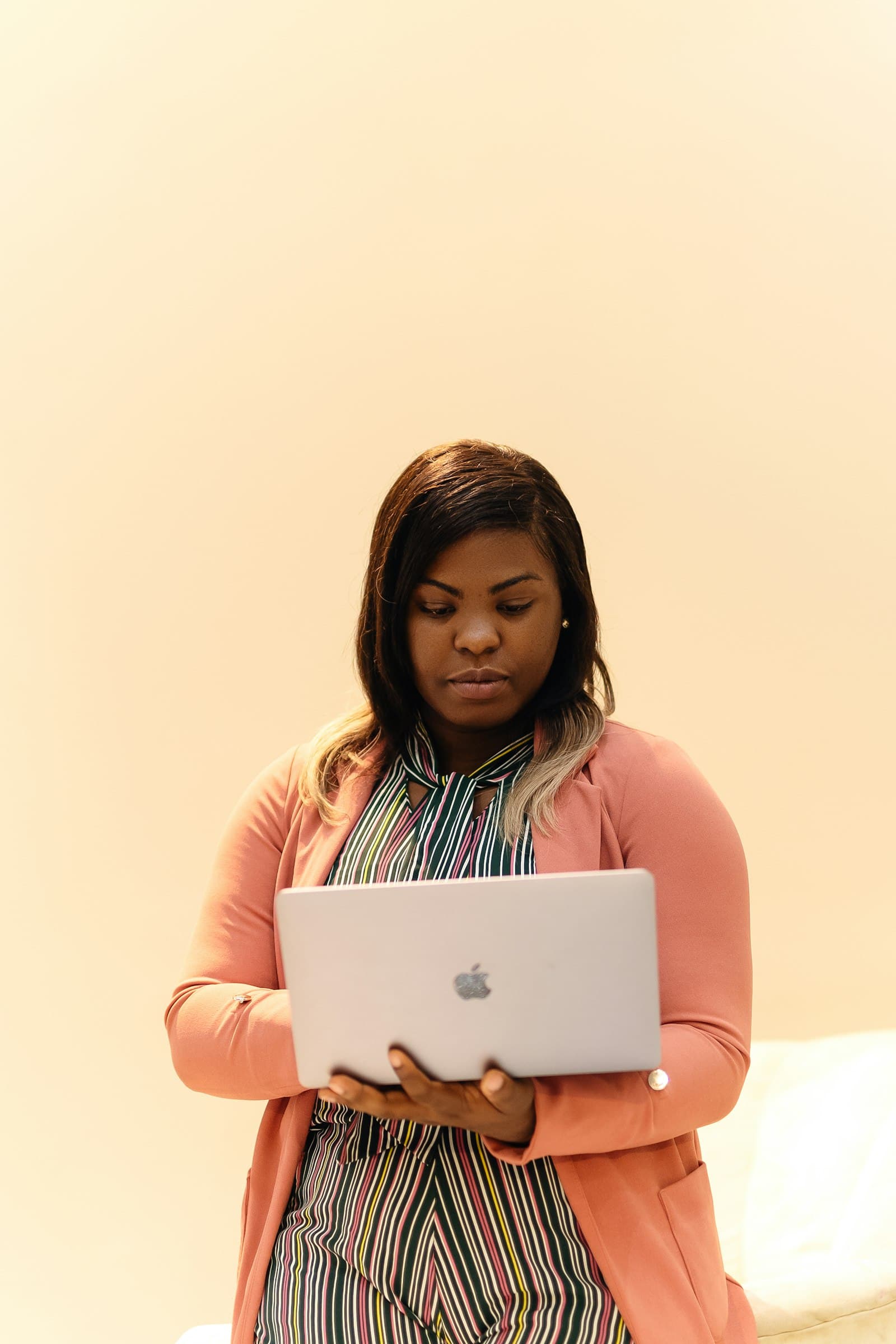 Professional woman standing beside her laptop