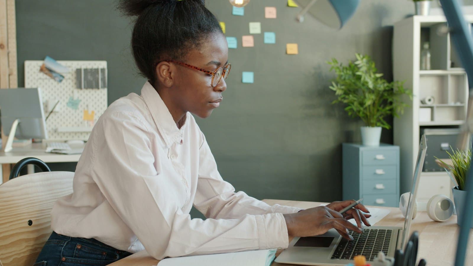 Professional woman working on a laptop in a modern office